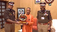 UP DGP Mukul Goel, ADG Prashant Kumar present memento, Police flag badge to CM Yogi