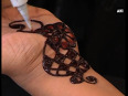Bangladeshi women paint hands with traditional henna designs ahead of eid