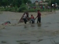 Watch Locals rescue man stranded in flood water