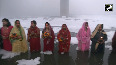 Women stand in knee-deep toxic foam for final day of Chhath Puja