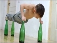 Kid does push ups on glass bottles