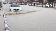 Vehicles struggle to cross a severely waterlogged road in Gujarat's Tharad following heavy rain