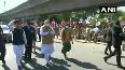 Amit Shah greets BJP workers lined up outside the airport in Chennai