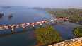 Magnificent aerial shot of train passing over Sharavathi bridge in K'taka