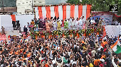 CM Yogi welcomes Kanwariyas with flower showers in Meerut