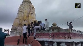 Devotees Climb Submerged Temple for Aarti in Banswara