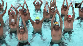 Video: Yoga enthusiasts perform asanas in water pool in Surat