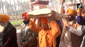 Yogi Adityanath carries Sikh Holy Book on his head on 'Veer Bal Diwas'