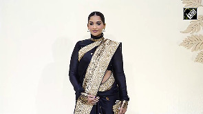 Sonam Kapoor flaunts her baby bump in a black Banarasi saree