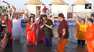 Devendra Fadnavis, wife Amruta take holy dip in Triveni Sangam