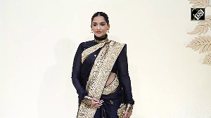 Sonam Kapoor flaunts her baby bump in a black Banarasi saree