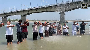 Officers take 'nectar bath' with the holy water of Triveni Sangam in Saryu river of Ayodhya