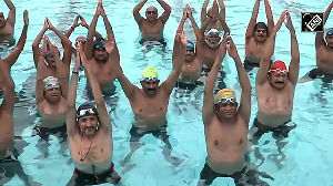 Video: Yoga enthusiasts perform asanas in water pool in Surat